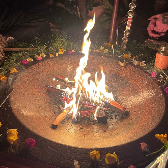 a sacred fire burn bright in a copper bowl