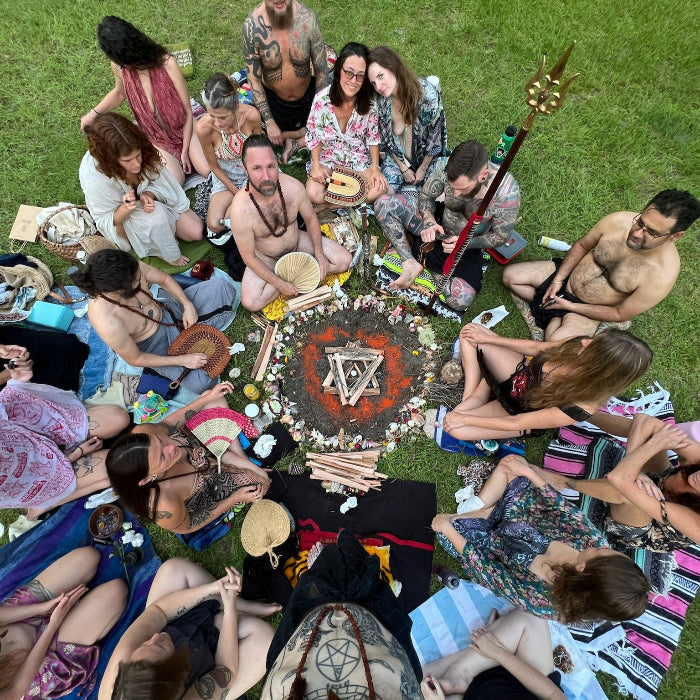 folks sitting around a sacred fire before ritual begins 